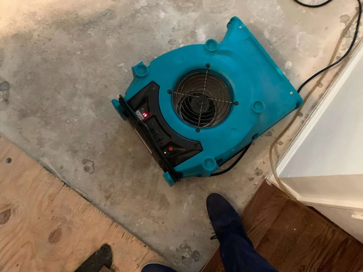 Air mover drying subfloor during Commercial Water Damage Restoration in Dalton